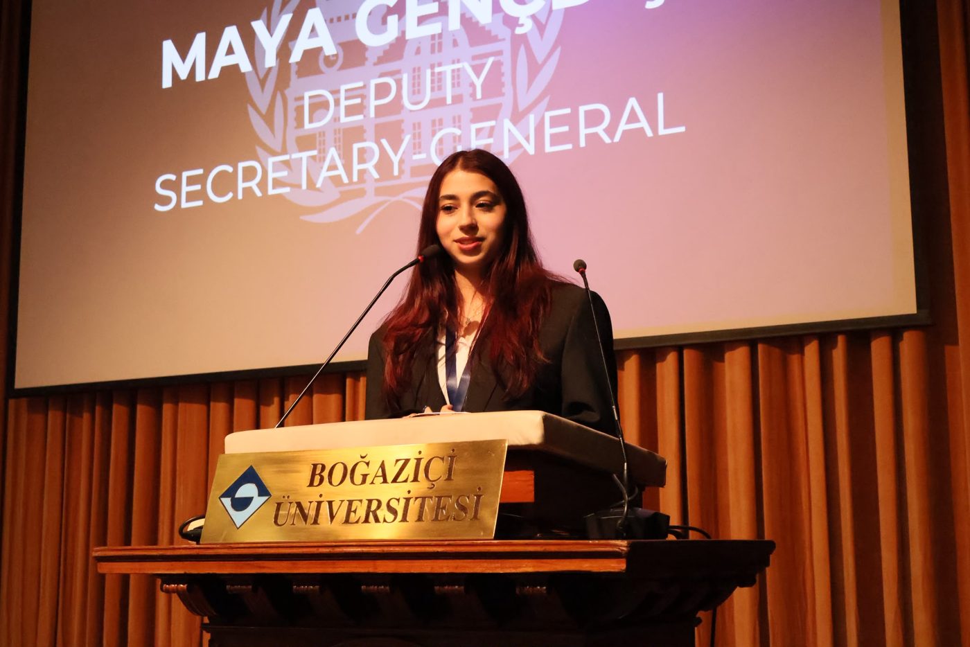 Maya Gençdiş speaking at the Albert Long Hall podium